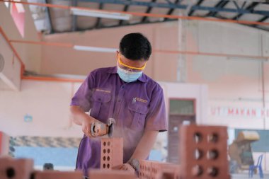 Muadzam Shah, Malaysia - August 25th, 2022: College students  working brick wall construction in bricklaying workshop