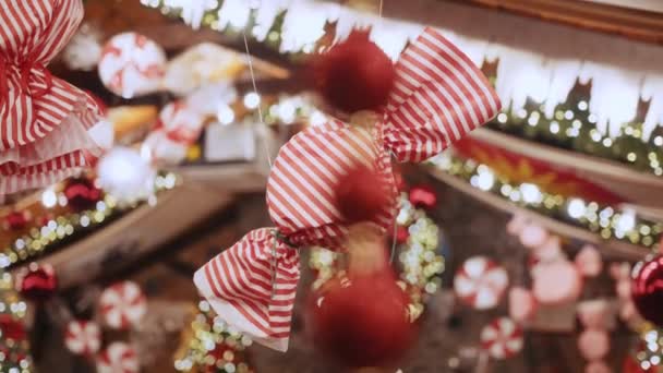 A large Christmas decoration in the form of candy hangs in a beautiful house or shop. Xmas ball and decoration candies on new year tree, christmas mood, merry christmas and happy new year — Stock Video