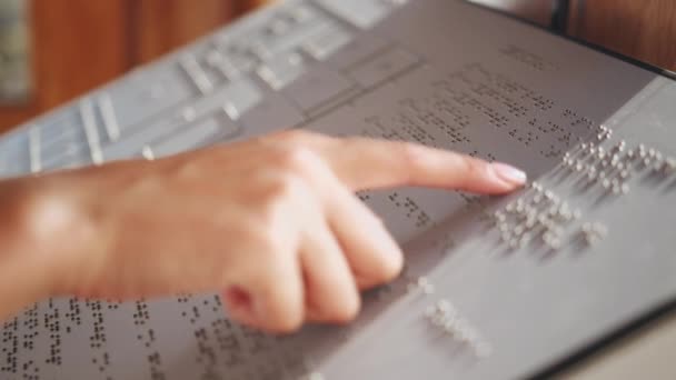 Touching letters on sheet of paper close-up, blindman reading braille book using his fingers, poorly seeing person learning to read, disabled people concept. — 图库视频影像