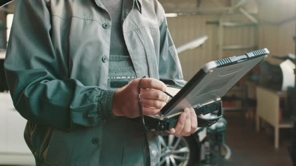 Car mechanic using laptop for checking car engine. Garage Automotive Tuning Adjustment Laptop Concept. Close up hand use computer Analyze car problems. The technician automotive using laptop. — Video