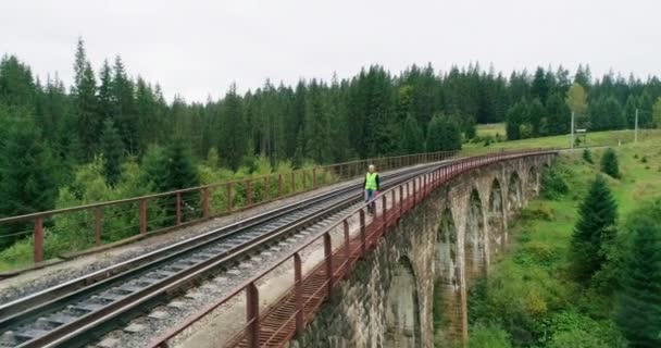 Aerial shot construction worker on railways. Engineer work on railway. An Engineer walking on railways with inspection railroad under maintenance period. Old railway bridge over a river. — 비디오