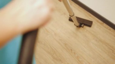 Professional maid cleaning and washing floor with machinery in industrial building. Technologies that facilitate cleaning. Modern household appliances.