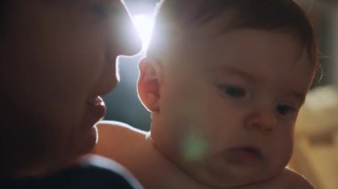 Caring Mom Hugging the Neonate Toddler and They are Bonding Before Sleep. Concept of Childhood, New Life, Parenthood. Happy Mother Holding Cute Newborn Baby. Mom and baby