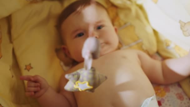 Playful Portrait of an Excited Neonate Toddler Looking at Rotating Toys. Concept of Childhood, New Life. Cute baby lying in his crib. Beautiful Close Up Footage of a Cute Newborn Baby Lying. — Stockvideo