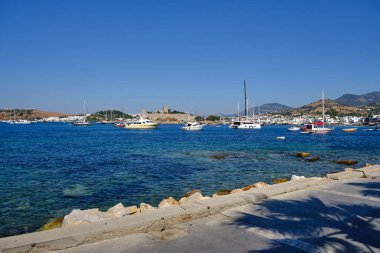 Boats and yachts on the pier. Tourists walk along the embankment of the resort town of Bodrum. Bodrum Turkey July 12, 2022. View of Marina
