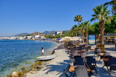 Boats and yachts on the pier. Tourists walk along the embankment of the resort town of Bodrum. Bodrum Turkey July 12, 2022. View of Marina
