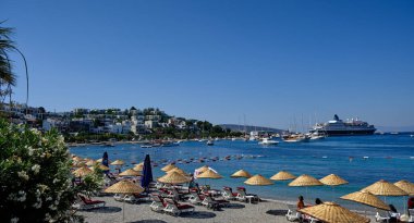 Boats and yachts on the pier. Tourists walk along the embankment of the resort town of Bodrum. Bodrum Turkey July 12, 2022. View of Marina