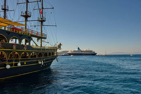 Boats and yachts on the pier. Tourists walk along the embankment of the resort town of Bodrum. Bodrum Turkey July 12, 2022. View of Marina