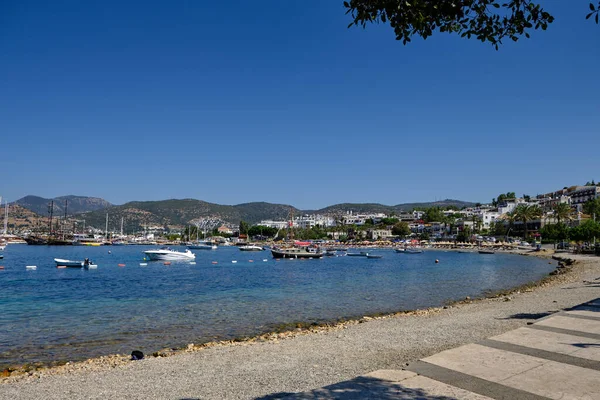 Boats and yachts on the pier. Tourists walk along the embankment of the resort town of Bodrum. Bodrum Turkey July 12, 2022. View of Marina
