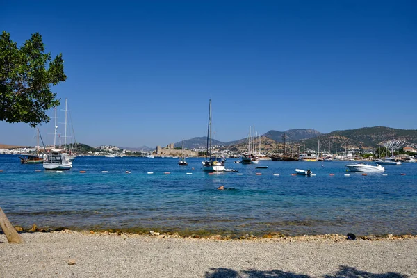 Boats and yachts on the pier. Tourists walk along the embankment of the resort town of Bodrum. Bodrum Turkey July 12, 2022. View of Marina