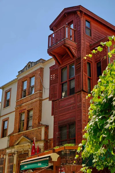 Istanbul, Turkey, July 18, 2022. Beautiful and colorful old buildings in the Arnavutkoy region on the embankment of Bosphorus. People walk the streets
