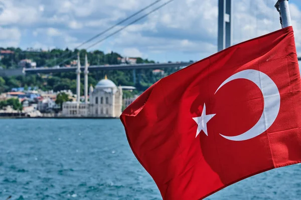 Istanbul, Turkey, Turkish flag against the background of the sky and the Bosphorus Strait close -up