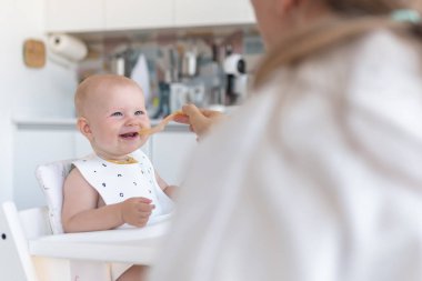 İlk önce bebekler beslenir, anne kaşıkla bebek besler.