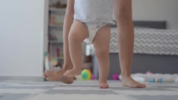 Baby first steps with mom bottom view legs — ストック動画