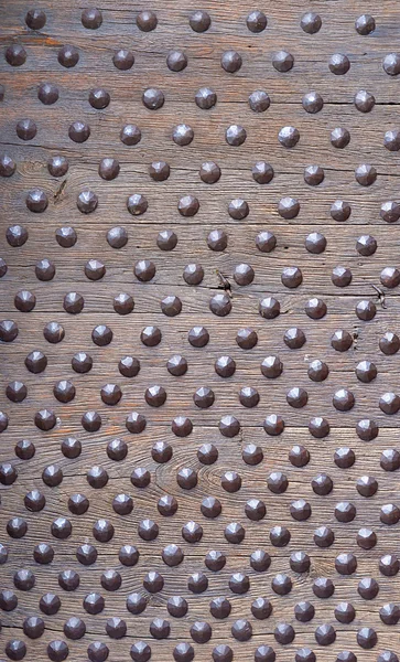 Studded, bolted, doornailed wood plank – stockfoto