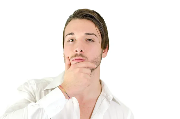 Handsome young man thinking, looking at camera — Stock Photo, Image