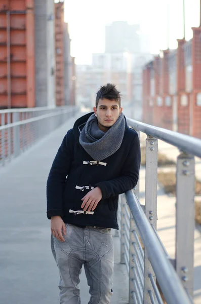 Handsome young man in urban or industrial setting — Stock Photo, Image