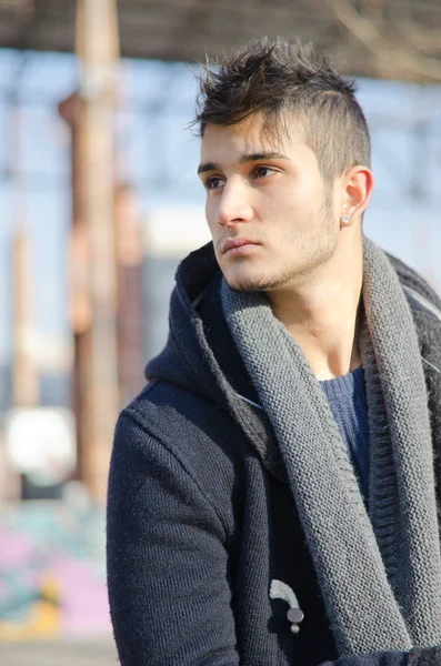 Handsome young man in urban or industrial setting — Stock Photo, Image