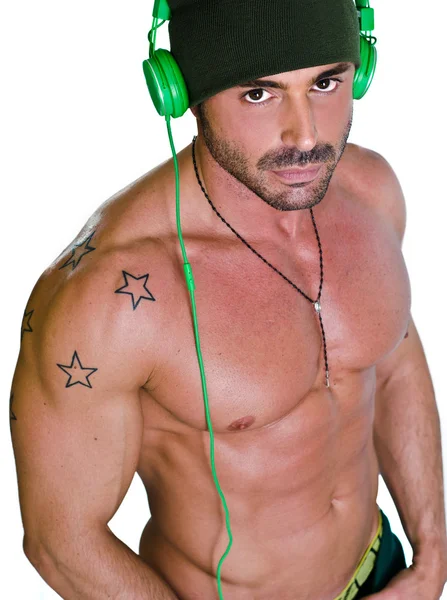 Muscular tanned shirtless man with headphones — Stock Photo, Image