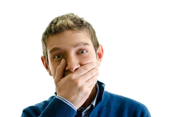 Snygg ung man som täcker munnen med handen — Stockfoto