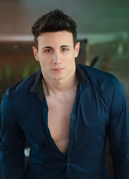 Handsome young man standing with open shirt showing torso — Stock Photo, Image