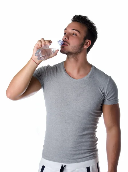 Handsome and athletic young man drinking water — Stock Photo, Image