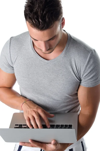 Hombre joven guapo usando ordenador portátil —  Fotos de Stock