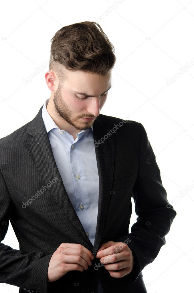 Handsome young man buttoning up jacket