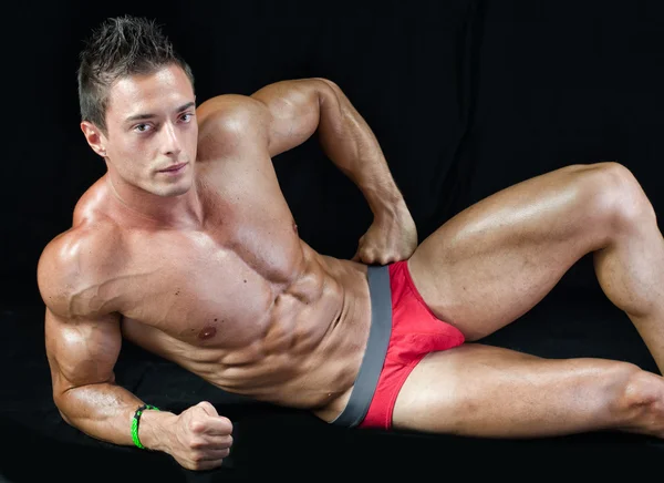 Attractive young muscle man on the floor with muscular ripped body — Stock Photo, Image