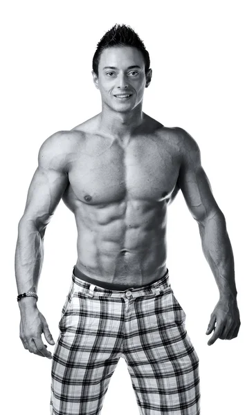 Handsome young muscle man shirtless with checkered shorts smiling — Stock Photo, Image