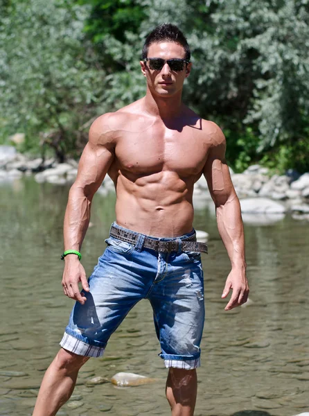 Attractive young muscleman in water pond — Stock Photo, Image