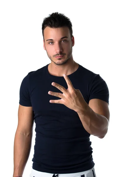 Handsome young man counting to four with fingers and hands — Stock Photo, Image