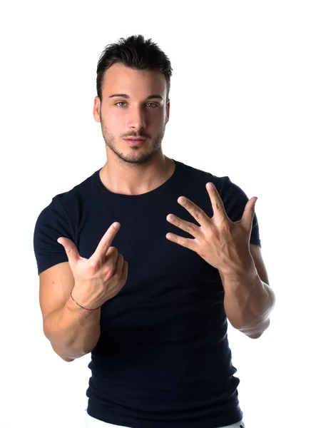 Handsome young man counting to seven with fingers and hands — Stock Photo, Image