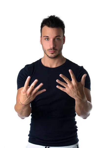 Handsome young man counting to nine with fingers and hands — Stock Photo, Image