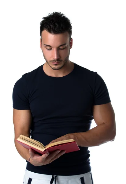 Attractive and athletic young man reading book — Stock Photo, Image