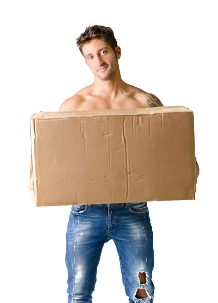 Handsome young man shirtless holding big cardboard box — Stock Photo, Image