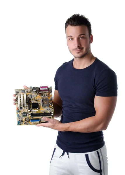 Smiling young man holding and showing computer motherboard — Stock Photo, Image