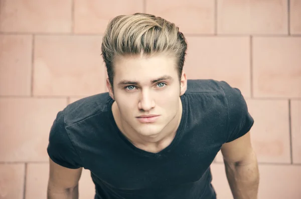 Attractive blond young man shot from above, looking up — Stock Photo, Image