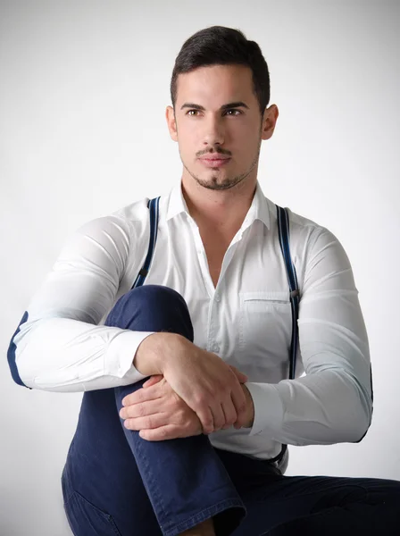 Elegant young man with white shirt and suspenders — Stock Photo, Image