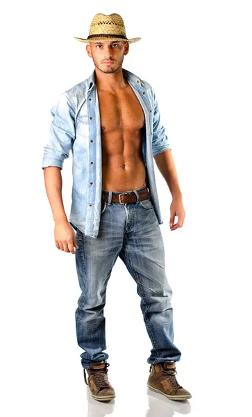 Handsome young man in jeans with straw hat — Stock Photo, Image