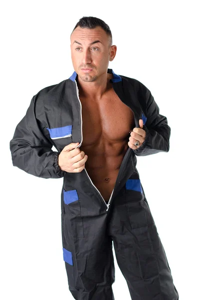 Bodybuilder mechanic opening coverall to show muscular body — Stock Photo, Image