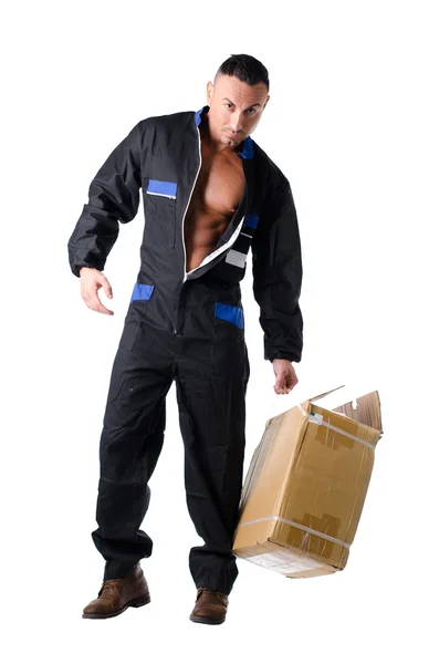 Muscular manual worker with open coveralls shows muscle torso and pecs – stockfoto