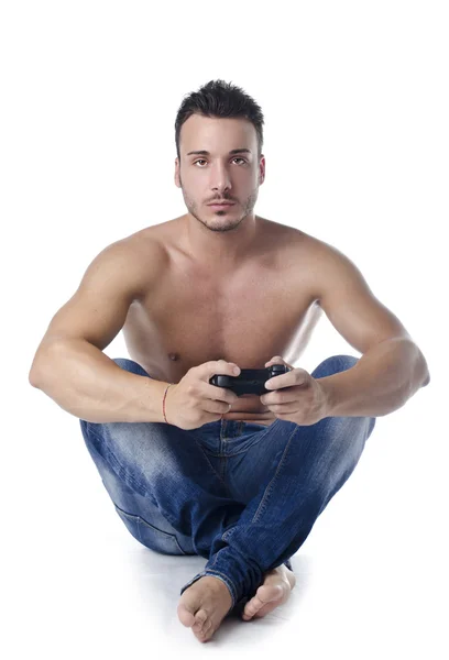 Handsome young man shirtless playing videogames with joypad — Stock Photo, Image