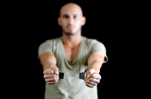 Handcuffs on bald young man, isolated on black — Stock Photo, Image