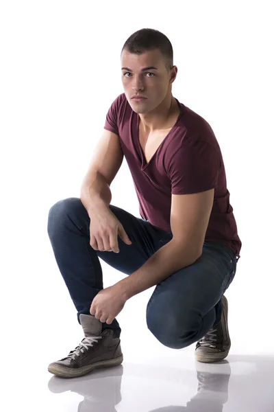 Full body shot of handsome young man sitting on floor — Stock Photo, Image