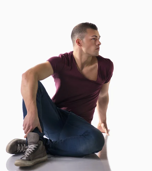 Full body shot of handsome young man sitting on floor — Stock Photo, Image