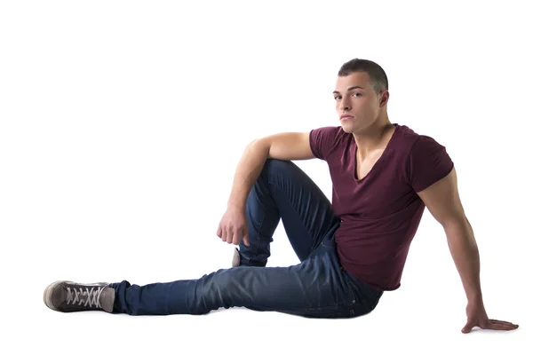 Full body shot of handsome young man sitting on floor — Stock Photo, Image