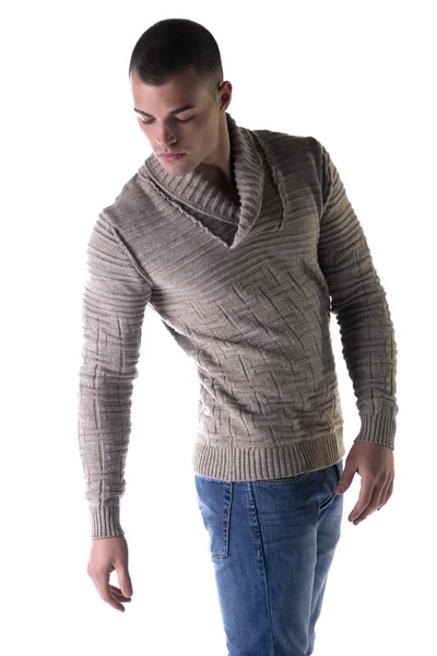 Attractive young man with wool sweater and jeans, looking down — Stock Photo, Image