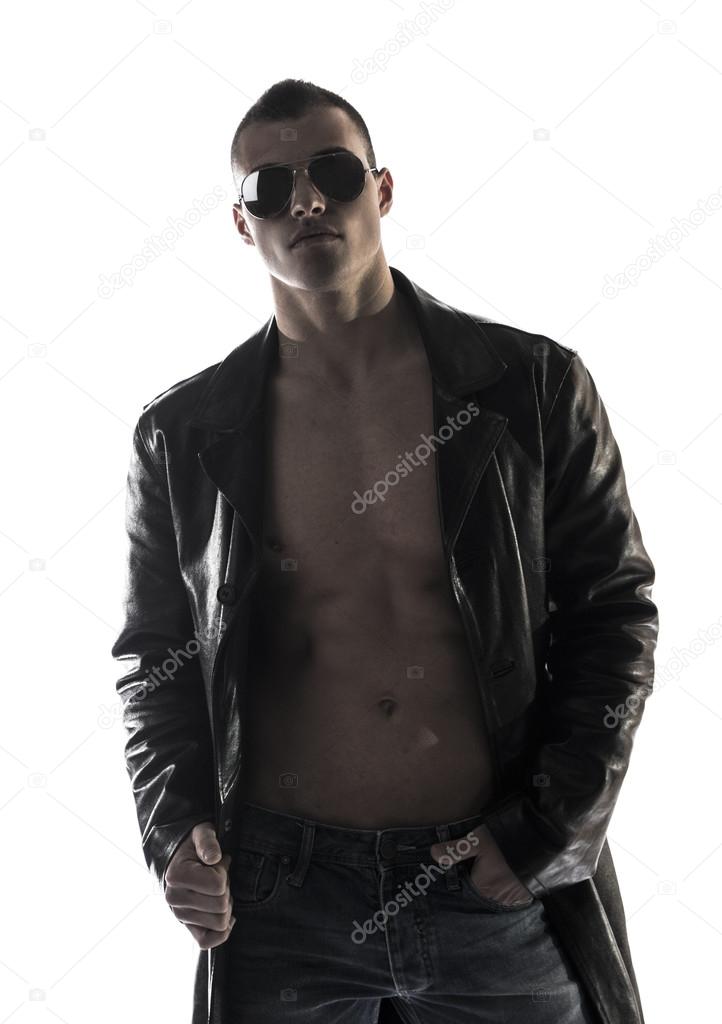 Muscular shirtless young man with leather jacket and sunglasses