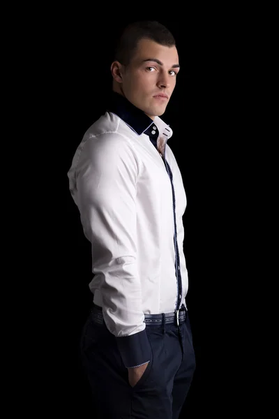 Attractive young man with white shirt, hands in pockets — Stock Photo, Image